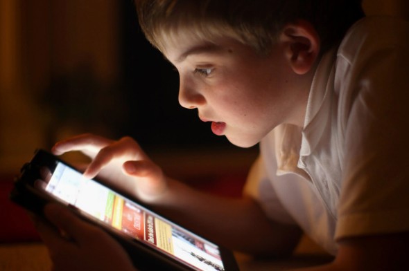 A-ten-year-old-boy-uses-an-Apple-Ipad-tablet-computer